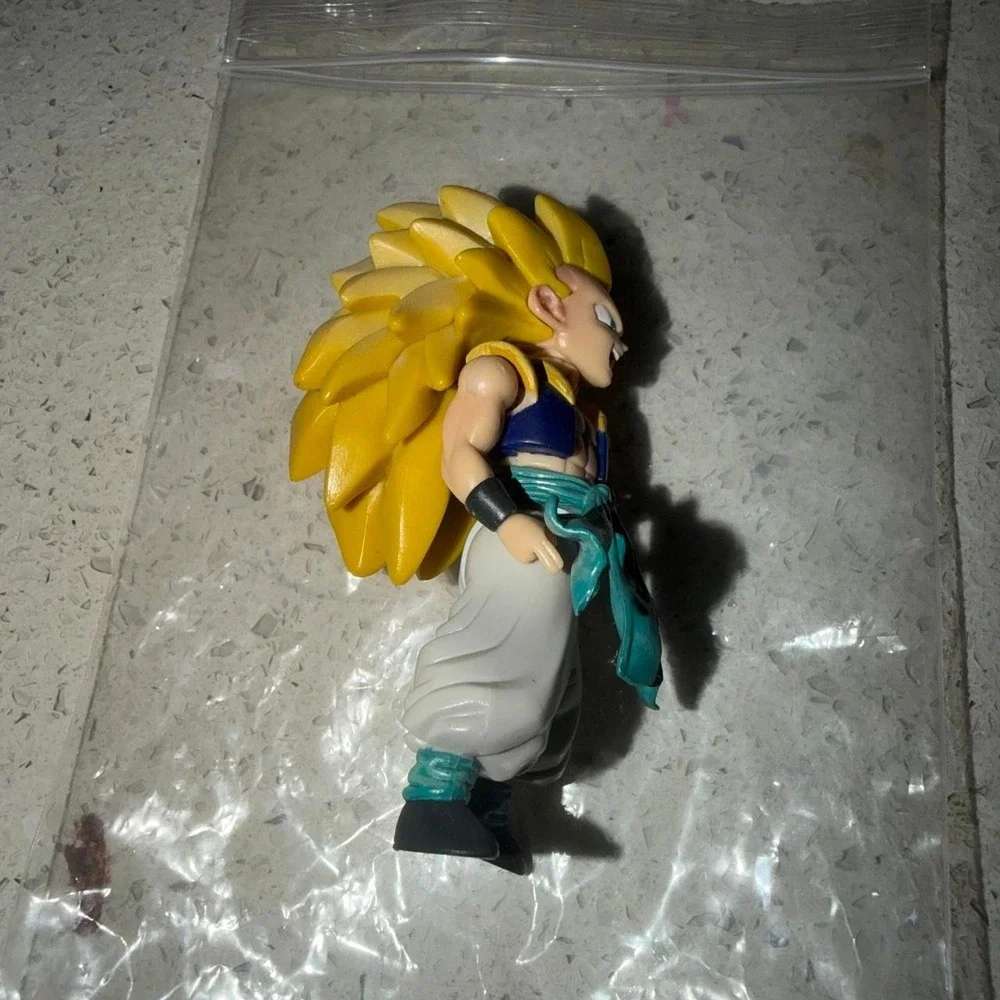 Dragon Ball Z Goku Super Saiyan 3 action figure with yellow spiky hair, blue